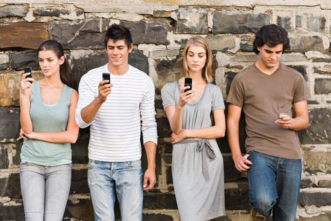 Young group using Tinder app on their smartphones