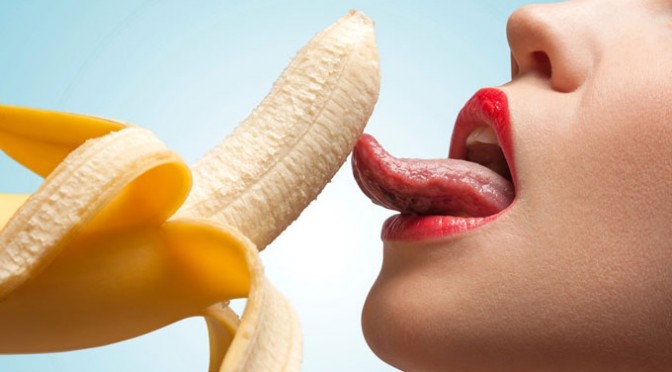 Woman lickinng a banana