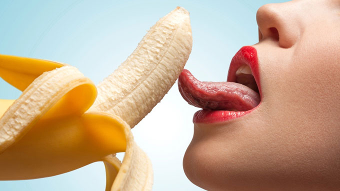 Woman lickinng a banana