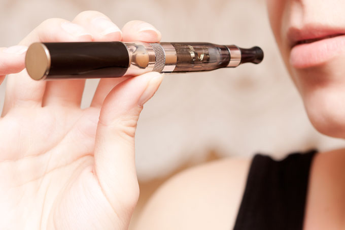 Woman Smoking Vaporizer eCig