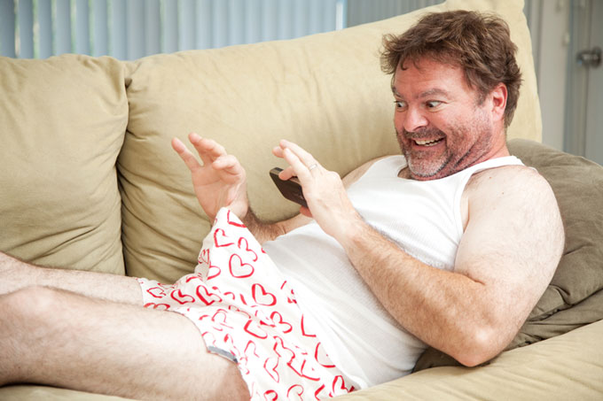 Middle aged man sexting from couch