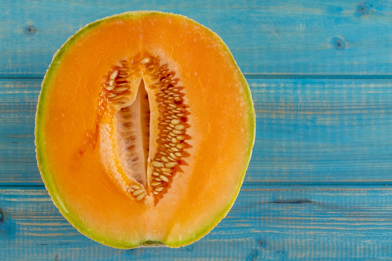 A cantaloupe in half which looks like a vagina