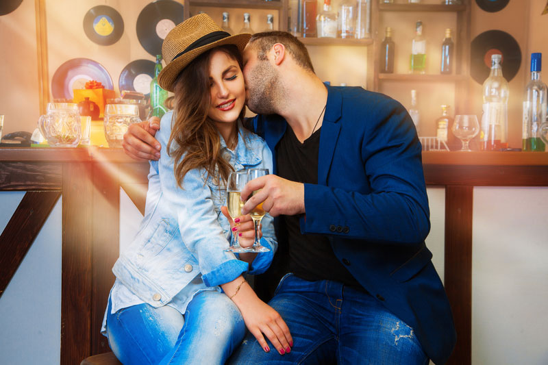 Confident guy kissing girl in the neck