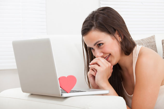 Girl browsing through guys' profiles on adult dating sites