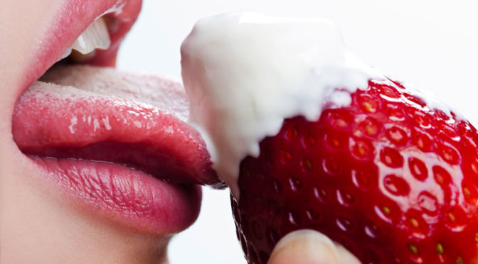 Sensual Woman Licking a Strawberry