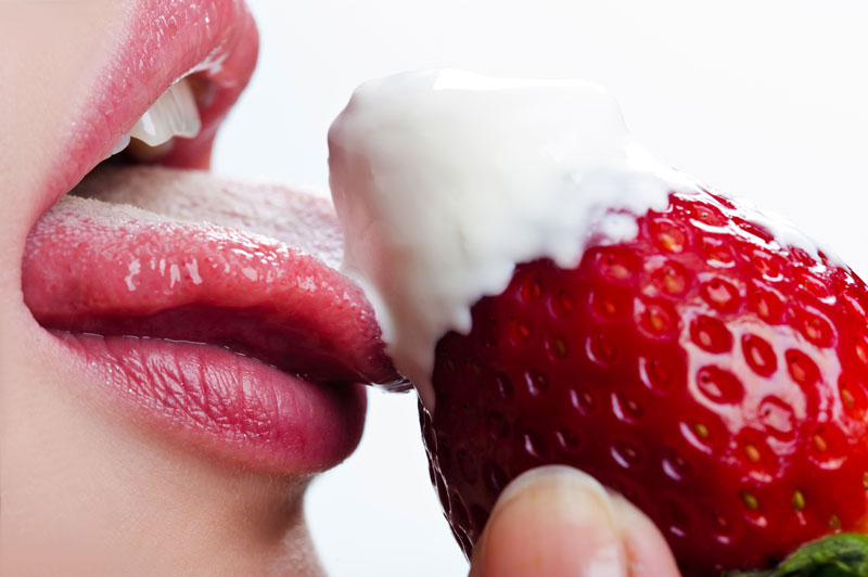 Sensual Woman Licking a Strawberry